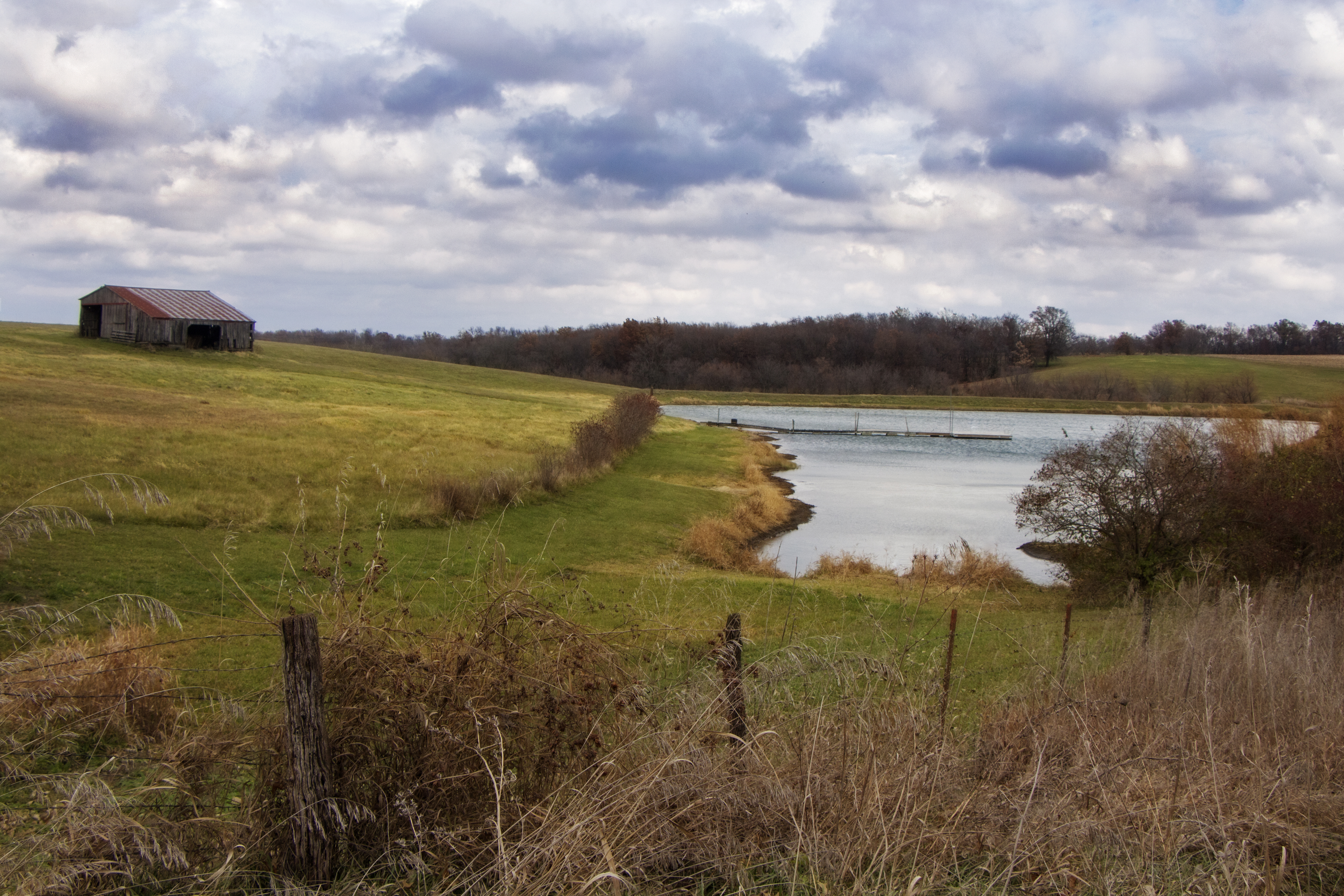 A farm with pond and a barn.